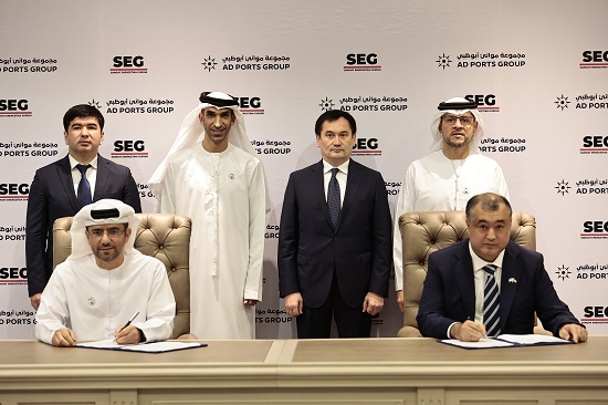 H.E. Dr Thani bin Ahmed Al Zeyoudi, UAE Minister of State for Foreign Trade (second to left, standing), witnesses the signing of the agreements between AD Ports Group and SEG in the presence of H.E. Ilkhom Makhkamov, Minister of Transport of Uzbekistan (second to the right, standing); H.E. Mohamed Ali Al Shorafa, Chairman of the Abu Dhabi Department of Economic Development (first to the right, standing); and Aziz Voitov, First Deputy Minister of Investments and Foreign Trade of Uzbekistan (first to the left, standing). The agreements were signed by Captain Mohammed Juma Al Shamisi, Managing Director and Group CEO AD Ports Group (first to the left, seated); and Bakhtiyor Fazilov, Chairman of the Board of SEG