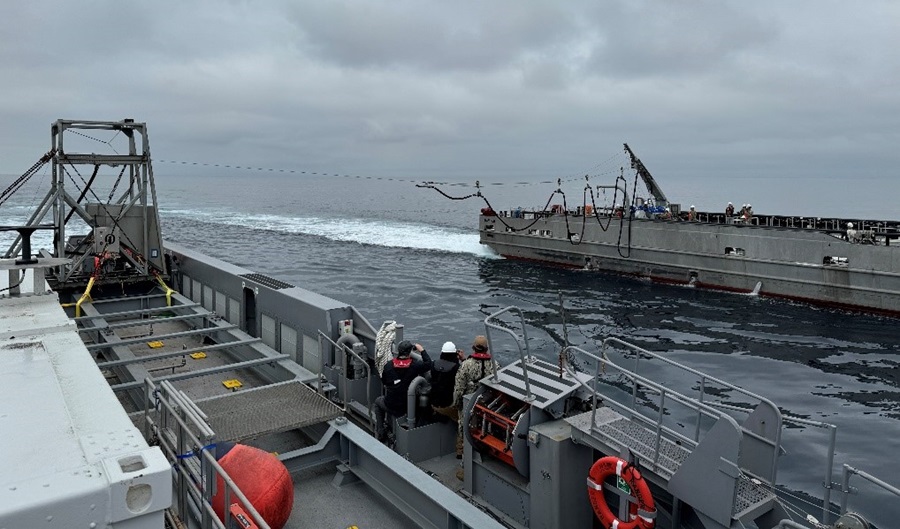 Caption: In a test as part of DARPA’s NOMARS program, the USV Mariner (right) deploys a refueling probe towards the USV Ranger (left) in the first test of fueling at sea (FAS) without any human interaction required on the part of the receiving vessel. The personnel aboard the Ranger are observers only. Credit: DARPA