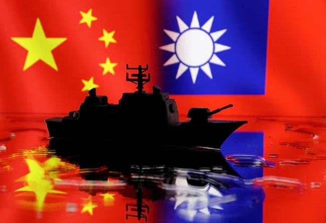 A Navy miniature is seen in front of displayed Chinese and Taiwanese flags in this illustration taken, April 11, 2023. REUTERS