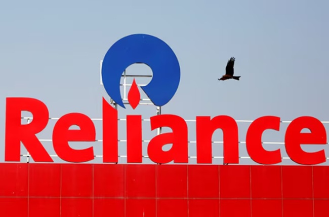 A bird flies past a Reliance Industries logo installed on its mart in Ahmedabad, India January 16, 2017. REUTERS/Amit Dave